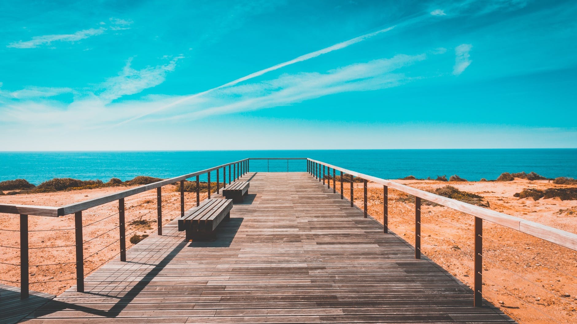 beach bench boardwalk clouds