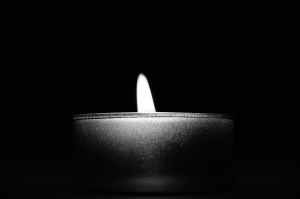 close up of candle over black background