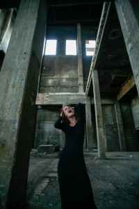 woman in black long sleeve dress screaming